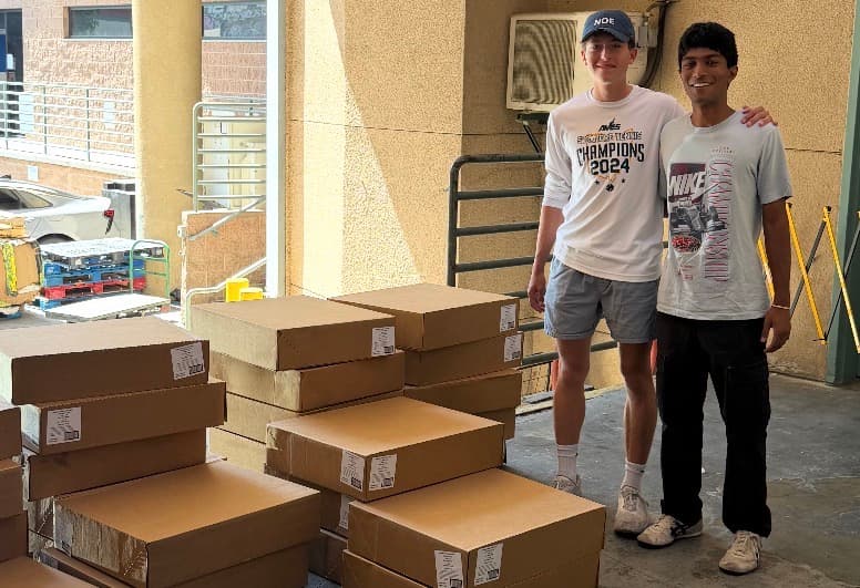 KneadLA volunteers with boxes of rescued baked goods at a loading dock