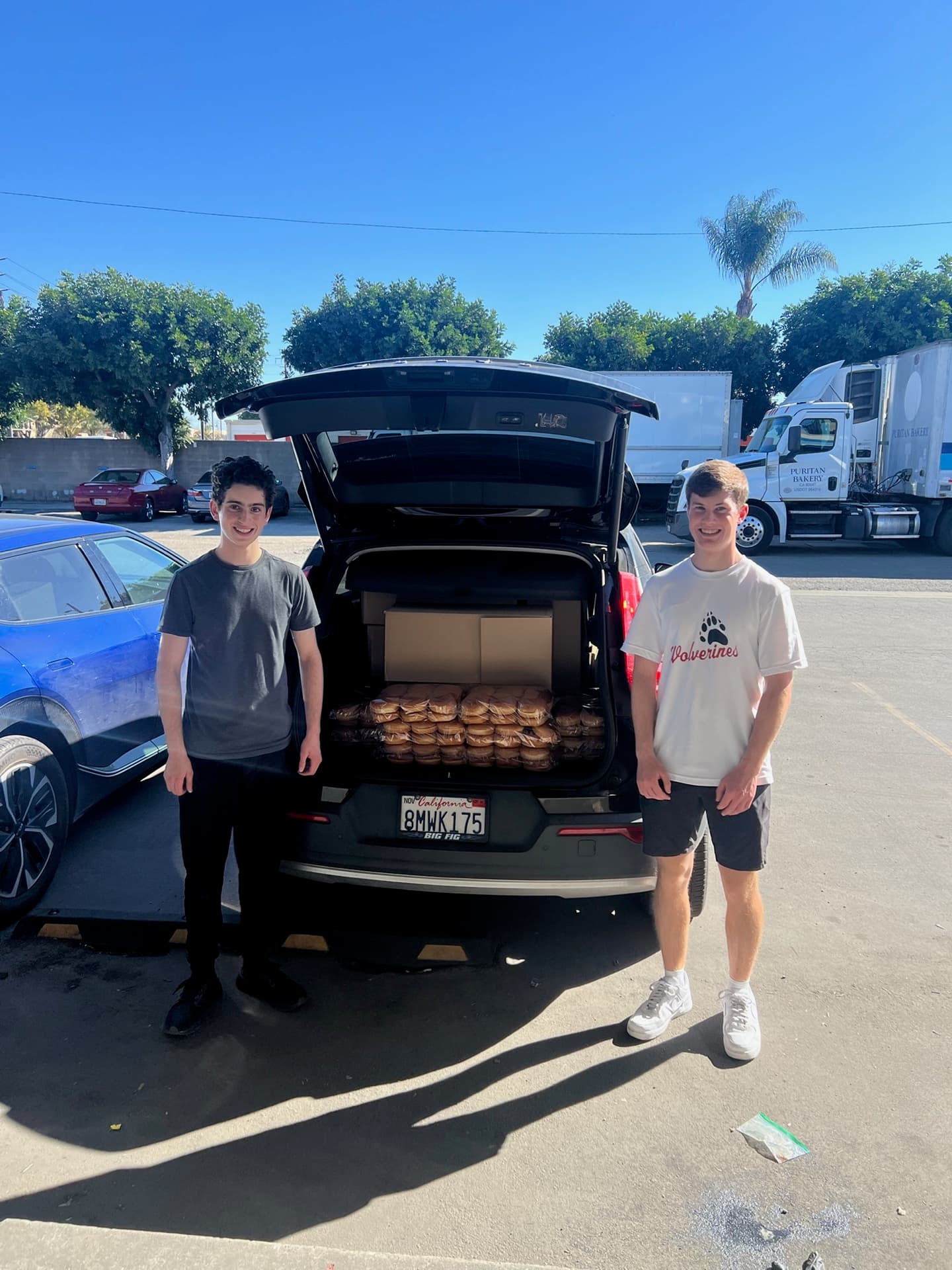 Volunteers loading rescued bread into a car