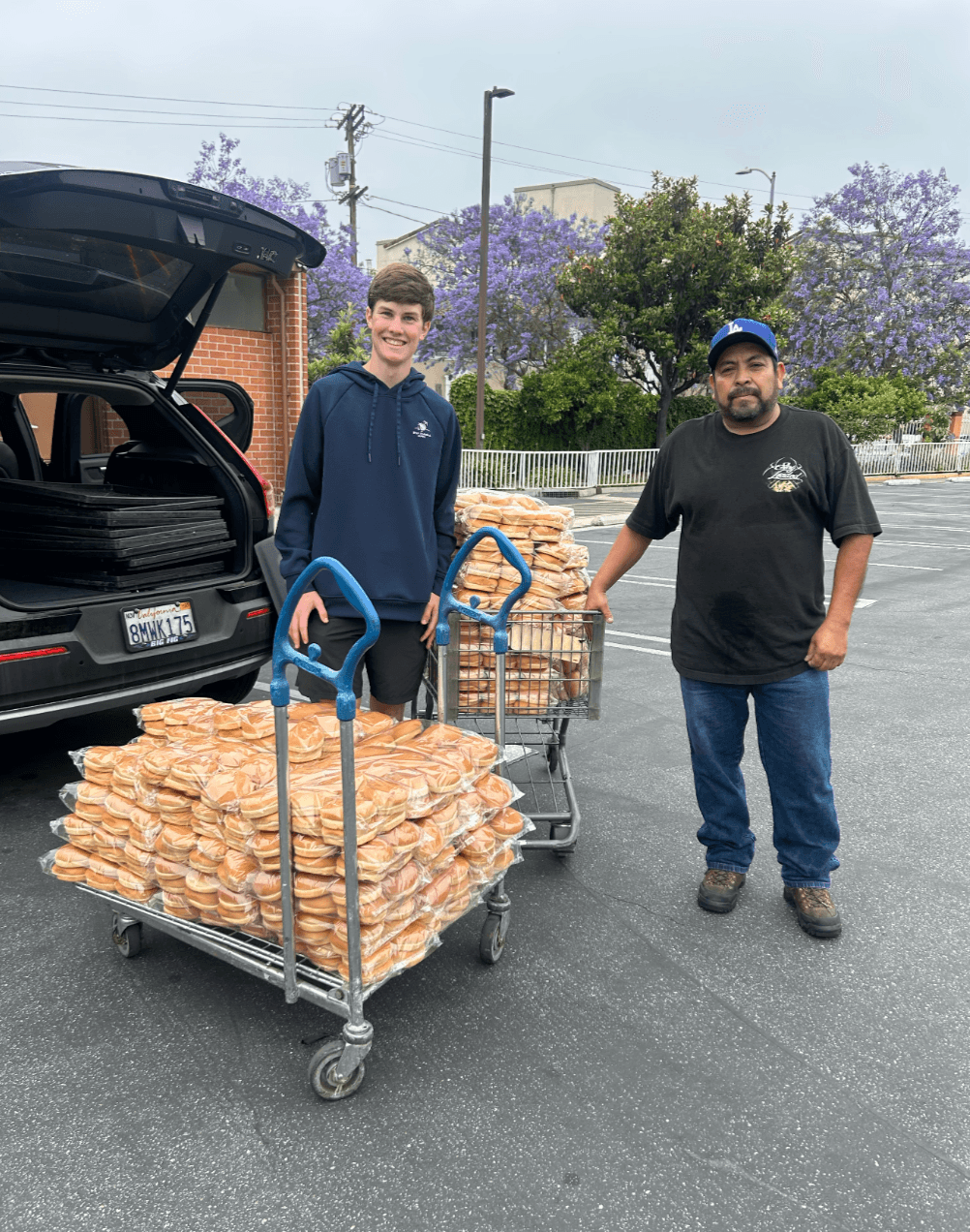 KneadLA volunteer with bread cart loaded for delivery