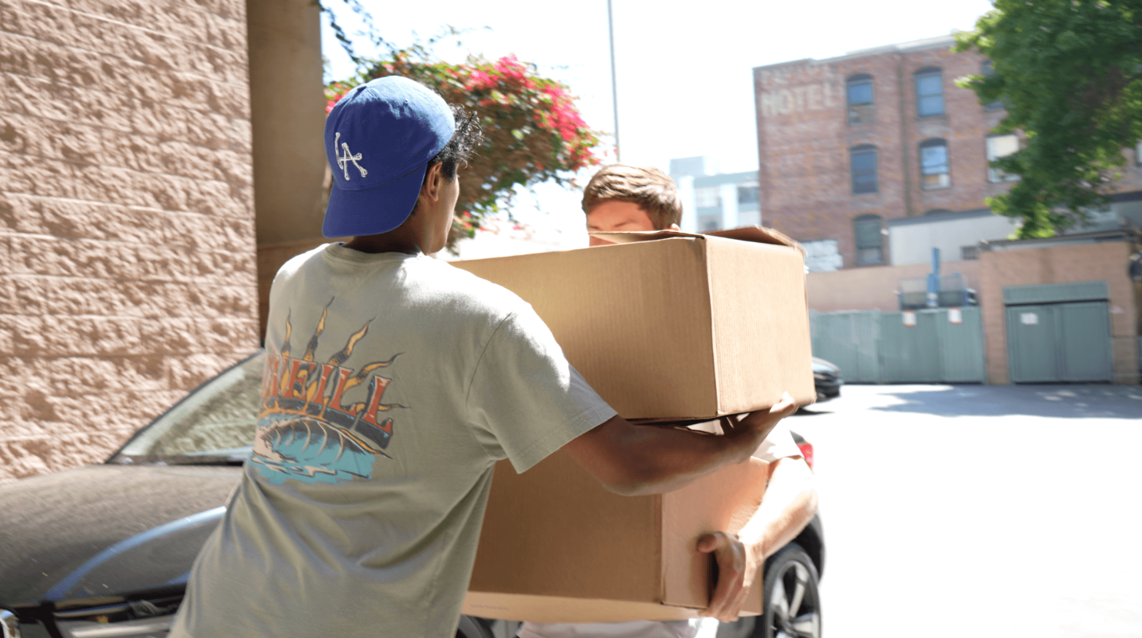 KneadLA volunteer carrying bread delivery boxes